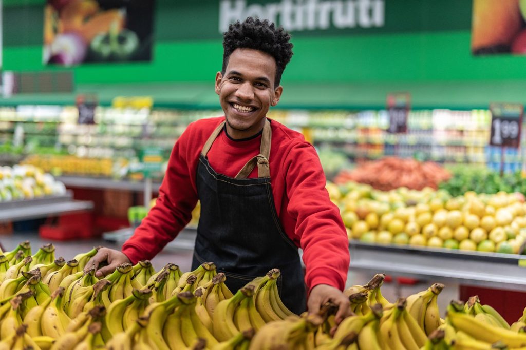 Man smiling in produce section