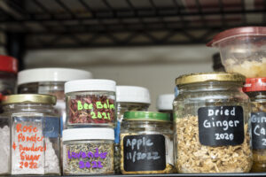 Spices from Dianne's garden on a kitchen spice rack, labeled with content and year